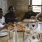 a group of people sitting around a table with pizzas