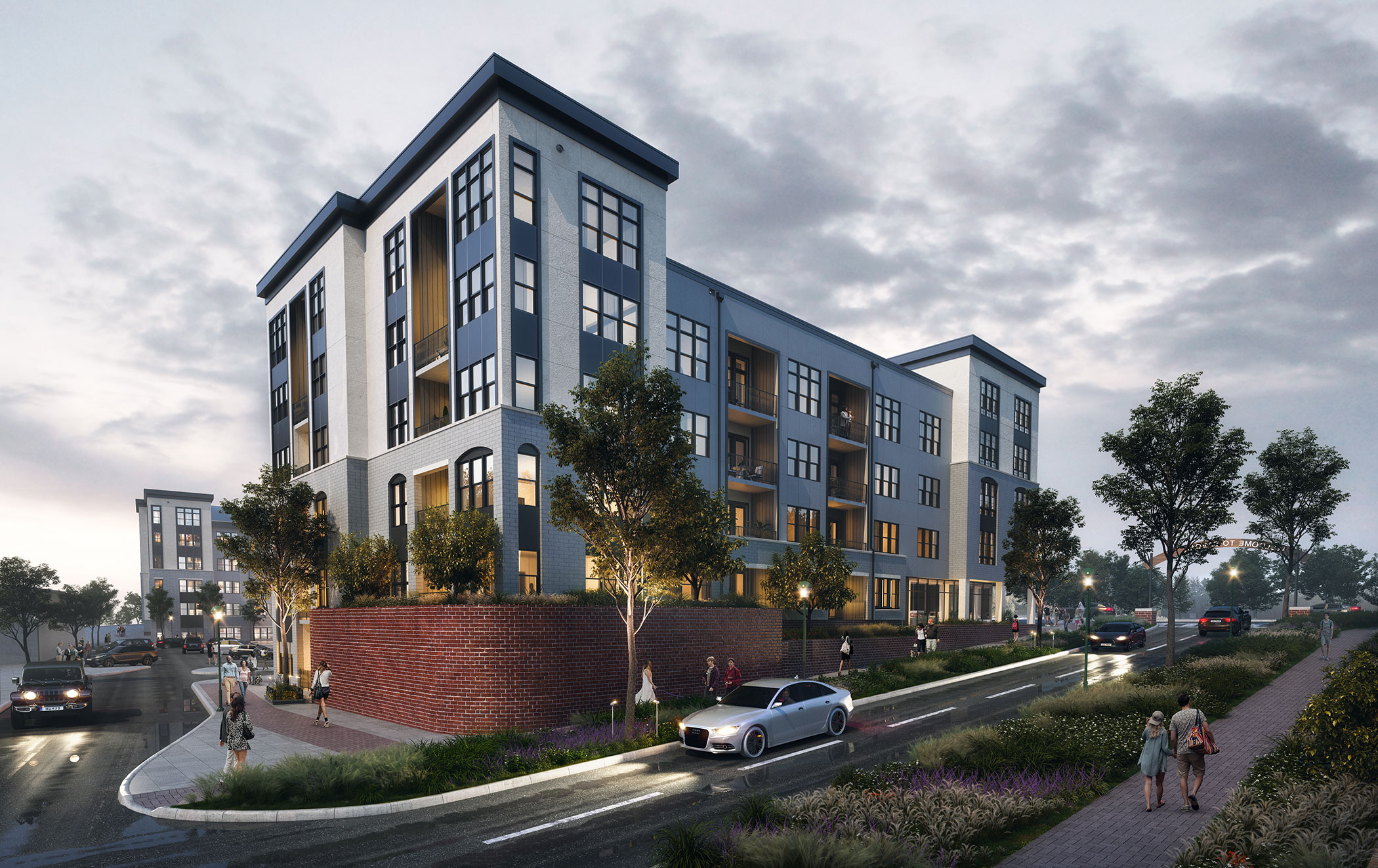 exterior view of apartment building at dusk with people on the sidewalk and cars driving past