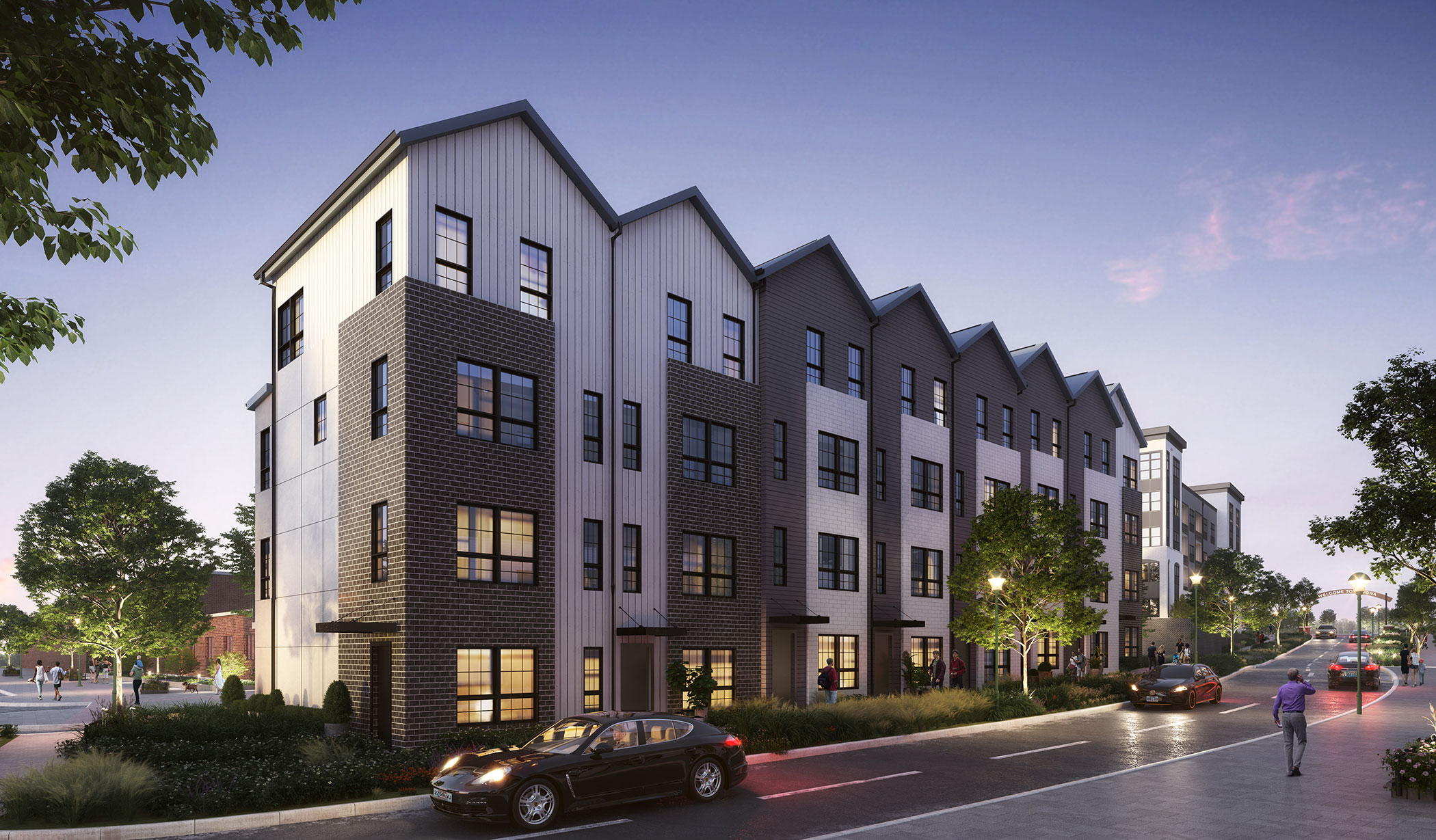 exterior street view of apartments at dusk with cars driving past